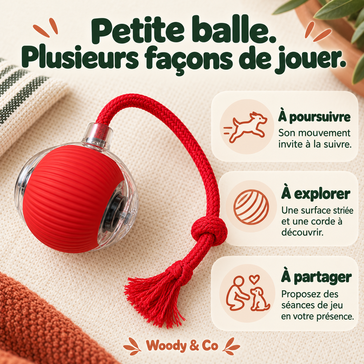 Balle interactive rouge avec corde tressée posée sur un plaid — mise en scène générée par IA